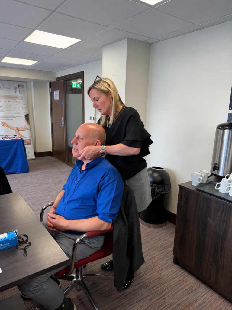 A delegate practising neck examination during a previous clinical skills workshop