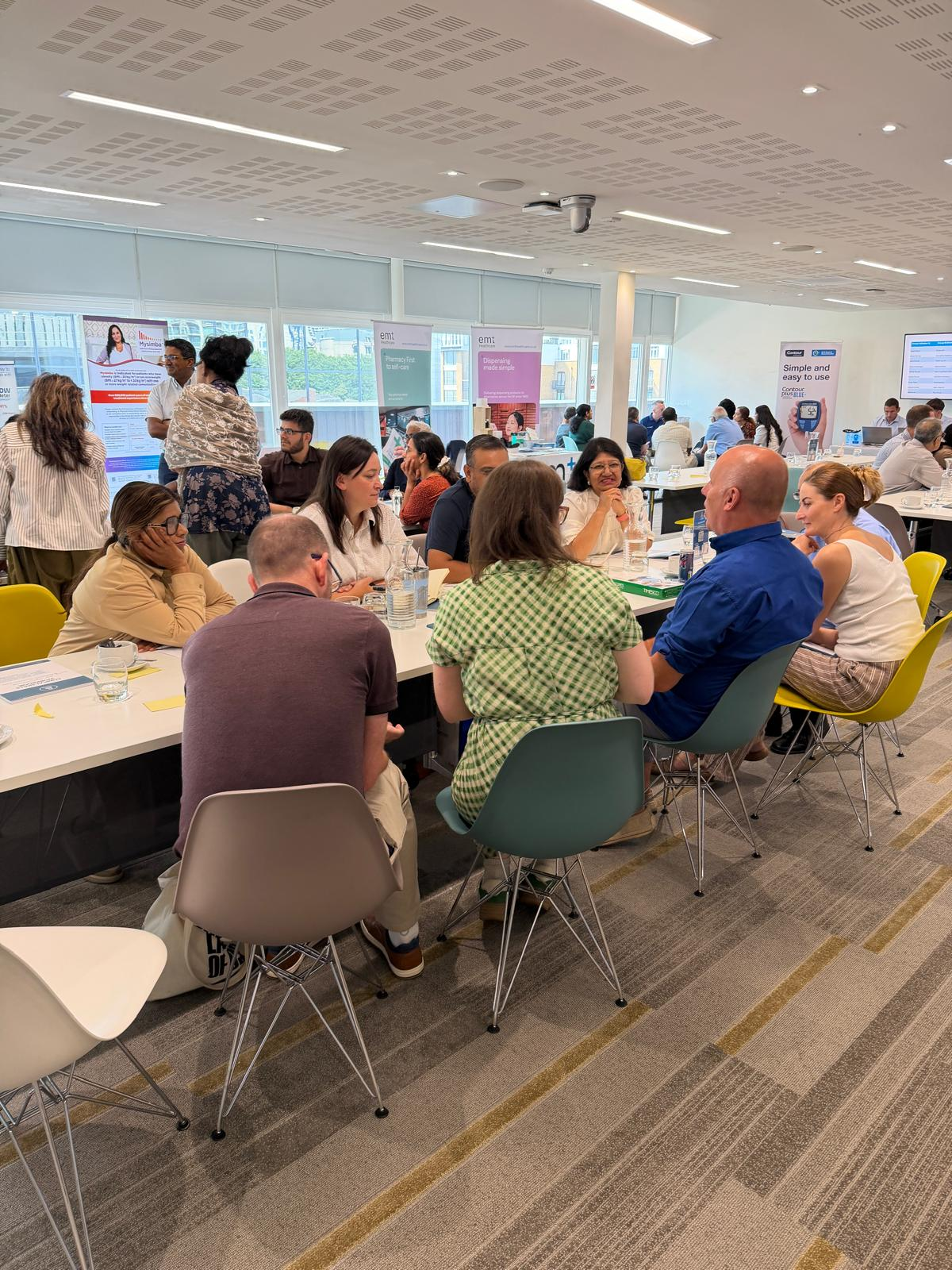 Delegates discussing cases in groups at a previous CliniLink workshop